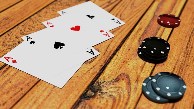 four aces black and red chips on table