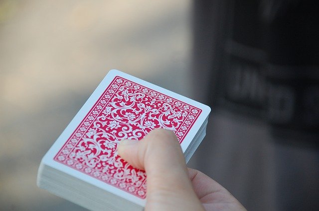 playing cards held by hand